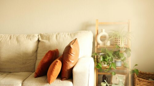 Minimalist Living Room Interior with Leather and Velvet Pillows Desktop Wallpaper
