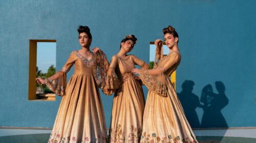 Three Elegant Women in Gold Designer Dresses Desktop Wallpaper