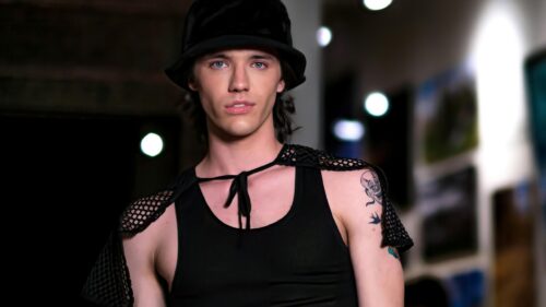 Stylish Male Model in Black Bucket Hat and Net Cape 4K Wallpaper