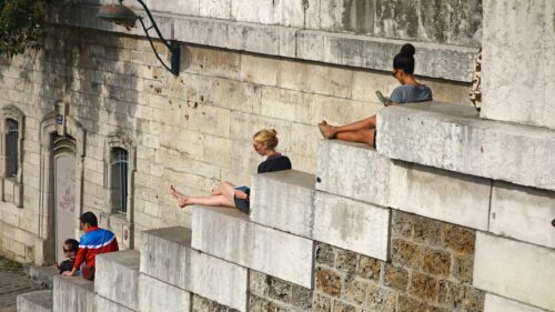 People Relaxing on Stone Steps in Paris 4K Desktop Wallpaper