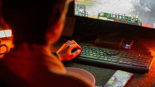 Gamer Playing Dota 2 in Dim Red Lighting 4K PC Wallpaper