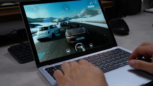 Racing Video Game Action on Laptop Screen 4K Wallpaper