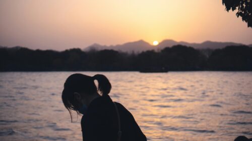 Silhouette Girl by the Lake at Sunset 4K Desktop Wallpaper