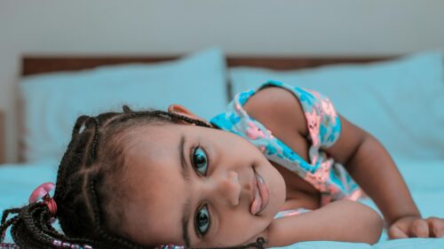 Adorable Young Girl With Braids Smiling Sweetly Desktop Wallpaper