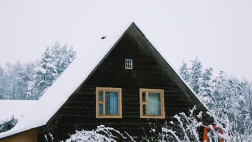 Cozy Snowy Cabin in Winter Forest Landscape 4K Wallpaper