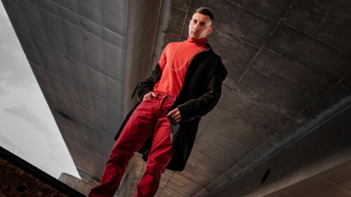 Stylish Man in Red Turtleneck and Black Coat 4K Desktop Wallpaper