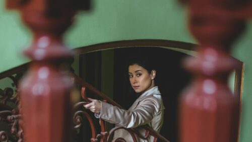 Elegant Woman on Vintage Staircase Cinematic Portrait 4K Wallpaper