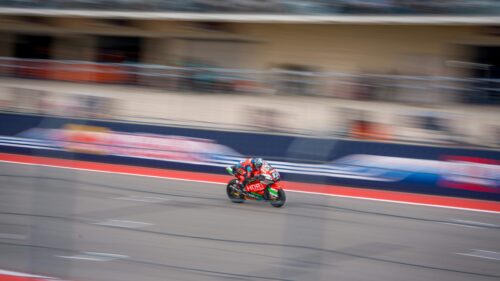 Red Racing Motorcycle at High Speed on Circuit Track 4K Wallpaper