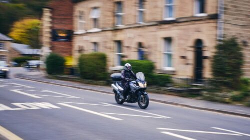Motorcyclist Riding on Historic Street Desktop Wallpaper