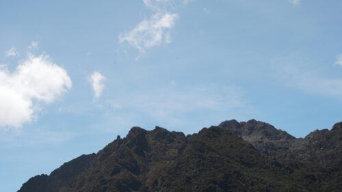 Dramatic Rocky Mountain Peak Under a Bright Blue Sky 4K Wallpaper