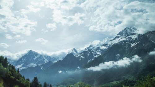 Majestic Snowy Alps Mountains Under Cloudy Blue Sky 4K Wallpaper