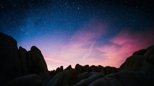 Mesmerizing Desert Night Sky with Glowing Clouds and Starry Galaxy 4K Wallpaper