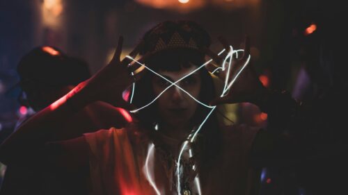Mysterious Woman with Neon Light Trails Dark Party 4K Wallpaper