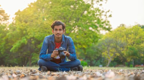 Young Photographer Sitting in Nature Portrait 4K Wallpaper