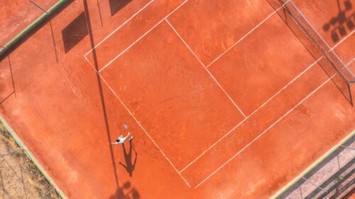 Aerial View Tennis Player Serving on Clay Court 4K Wallpaper