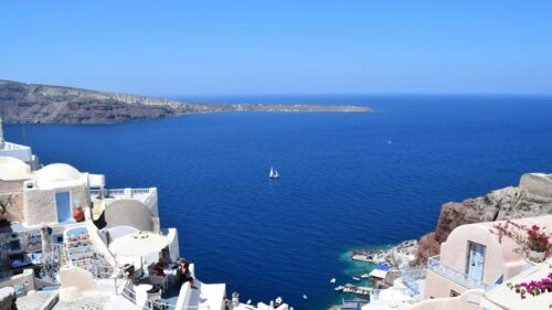 Santorini Oia View Blue Sea and Sailboat 4K Desktop Wallpaper