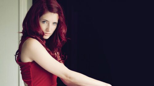 Stunning Woman with Vibrant Red Hair and Elegant Red Dress PC Wallpaper