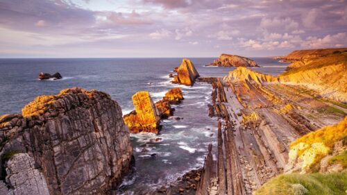 Breathtaking Coastal Rock Formations at Sunset Golden Hour PC Wallpaper