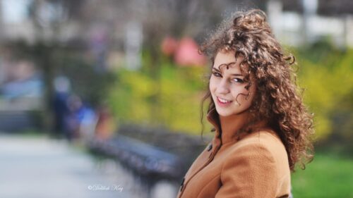 Beautiful Young Woman With Curly Hair in a Brown Coat Portrait PC Wallpaper
