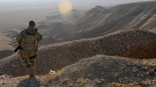 Solitary Soldier Observing Desert Landscape PC Wallpaper