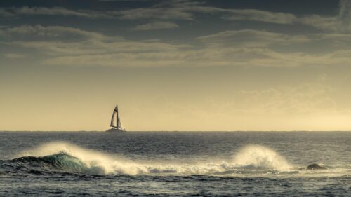 Sailboat Sailing on Ocean Waves at Sunset 4K PC Wallpaper