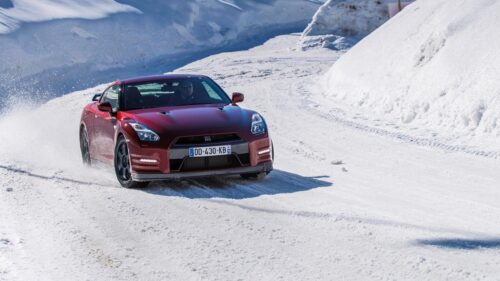 Red Nissan GT R Driving Through Snowy Mountain Road PC Wallpaper
