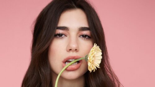 Stunning Portrait of Dua Lipa with Flower Desktop Wallpaper