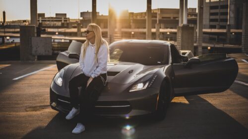 Stylish Blonde Woman Sitting on Luxury Sports Car at Sunset PC Wallpaper