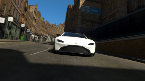 White Aston Martin Vantage Driving Through City Streets 4K Wallpaper