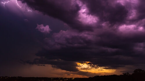 Dramatic Purple Lightning Storm Over Sunset Horizon 4K Wallpaper