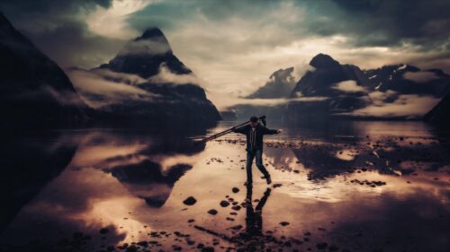 Photographer at Milford Sound Mist Mountains Landscape 4K Wallpaper