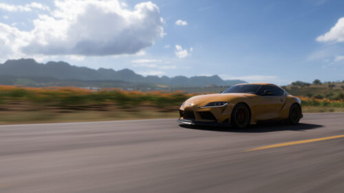 Stunning Yellow Toyota Supra Speeding on Coastal Road 4K Wallpaper