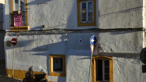 Charming Portuguese Street Scene with Traditional White House 4K Wallpaper