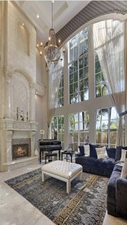 Beautiful great room_ The tall ceilings_windows create such drama. Fireplace at sitting height for a lovely balanced room
