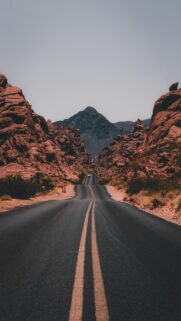 Serenity Landscape – Black Concrete Road Surrounded by Brown Rocks