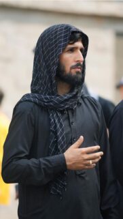 Mourning on Ashura: Man in Black Traditional Clothing