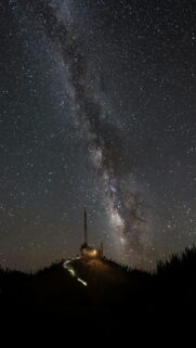 Milky Way Galaxy View from a Lit Tower on a Hill