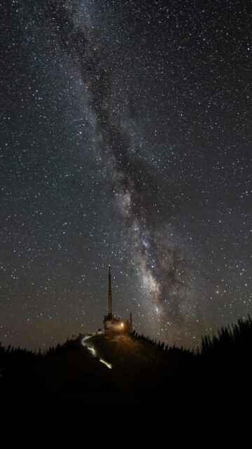 Milky Way Galaxy View from a Lit Tower on a Hill