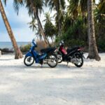 Coastal Duo: Two Motorcycles on a Sandy Beach