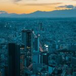 Dusk City Skyline with Distant Mountains