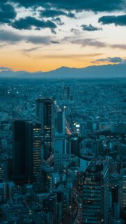 Dusk City Skyline with Distant Mountains