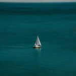 Serenene Scene: White And Brown Boat In Body Of Water