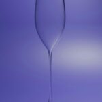 Clear Champagne Flute on Purple Background