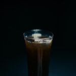 Dark Beverage in a Clear Glass with Ice