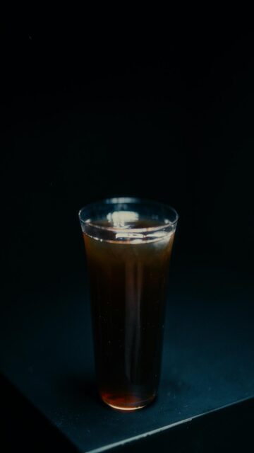 Dark Beverage in a Clear Glass with Ice