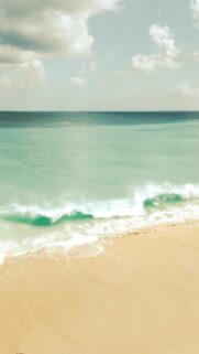 Coastal Serenity: Gentle Waves on a Sandy Beach