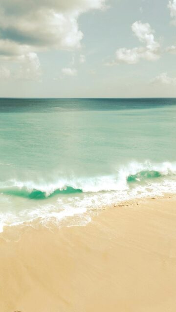 Coastal Serenity: Gentle Waves on a Sandy Beach