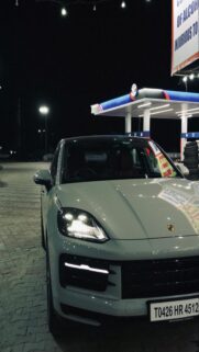 Light Grey Porsche Cayenne at Gas Station
