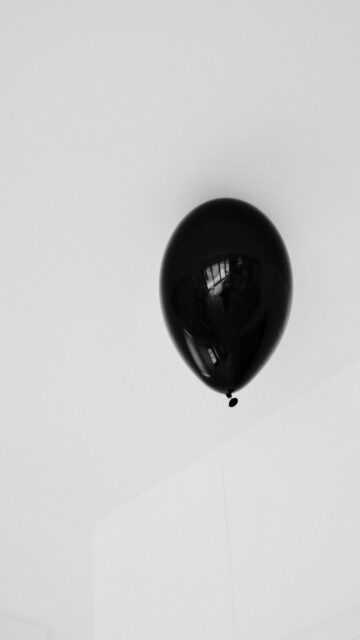 Minimalist Mobile Background: Single Black Balloon
