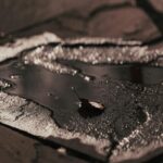 Single Leaf Puddle Dark Pavement Mobile Wallpaper
